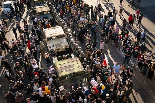 National Guard troops were surrounded by protesters in downtown Minneapolis on Friday after being activated by the governor.