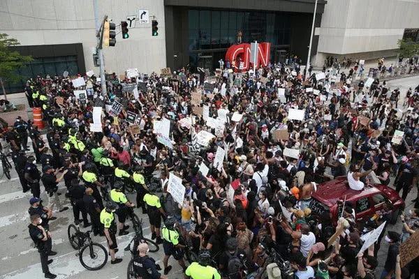Police officers and protesters in a standoff in front of the CNN headquarters in Atlanta on Friday.
