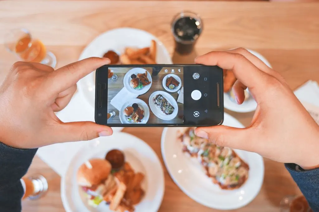 Clicking pictures of food for posting on social media
